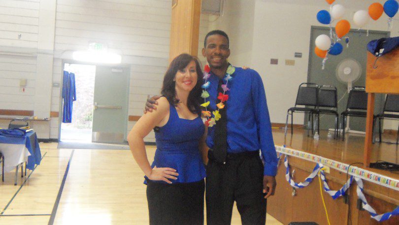 Couple wearing blue and colorful lei